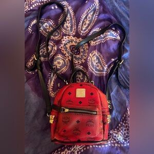 Wonderful red and black MCM backpack. Excellent use condition w no noted flaws!!